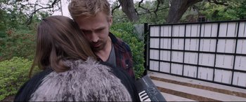 Movie still from “Song to Song” (2017), directed by Terrence Malick – A man and a woman hugging each other outside; Close Up shot, Over the shoulder angle