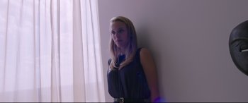 Movie still from “Song to Song” (2017), directed by Terrence Malick – A woman leaning up against a white wall; Medium shot, Low angle