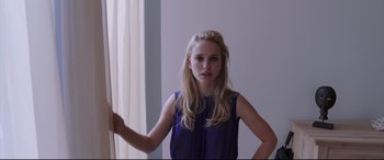Movie still from “Song to Song” (2017), directed by Terrence Malick – A woman standing in front of a white wall; Close Up shot, Over the shoulder angle