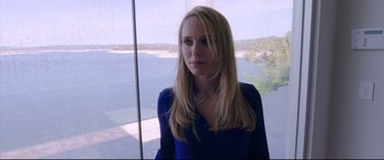 Movie still from “Song to Song” (2017), directed by Terrence Malick – A woman in a blue shirt looking out of a window; Close Up shot, Over the shoulder angle