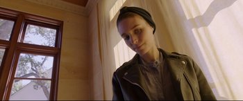 Movie still from “Song to Song” (2017), directed by Terrence Malick – A woman wearing a head scarf and a leather jacket; Close Up shot, Low angle