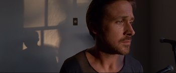 Movie still from “Song to Song” (2017), directed by Terrence Malick – A person wearing a black t - shirt; Close Up shot, Low angle