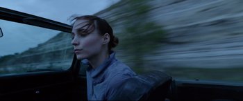Movie still from “Song to Song” (2017), directed by Terrence Malick – A woman with a backpack is driving a car; Close Up shot, Low angle