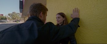 Movie still from “Song to Song” (2017), directed by Terrence Malick – A man and a woman standing next to each other; Medium shot, Over the shoulder angle