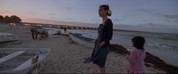 Movie still from “Song to Song” (2017), directed by Terrence Malick – A woman standing on a beach near a boat; Wide shot, Low angle