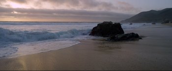 Movie still from “Song to Song” (2017), directed by Terrence Malick – The waves are crashing on the shore of the beach; Extreme Wide shot, High angle