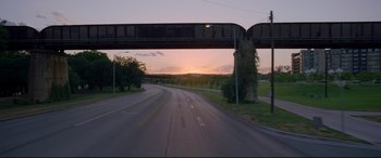Movie still from “Song to Song” (2017), directed by Terrence Malick – A view from a car looking at a bridge at sunset; Extreme Wide shot, Low angle