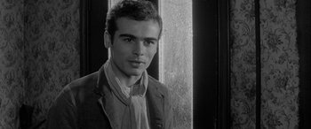 Movie still from “Sons and Lovers” (1960), directed by Jack Cardiff – Black and white photograph of a young man in a suit; Close Up shot, Over the shoulder angle
