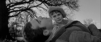 Movie still from “Sons and Lovers” (1960), directed by Jack Cardiff – A man and a woman in a wooded area looking at the camera; Close Up shot, High angle