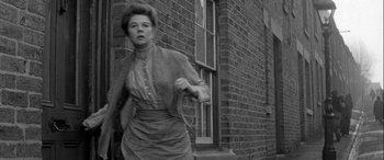 Movie still from “Sons and Lovers” (1960), directed by Jack Cardiff – An old photo of a woman walking down the street; Medium shot, Low angle