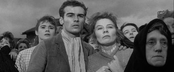 Movie still from “Sons and Lovers” (1960), directed by Jack Cardiff – A man and a woman standing next to each other; Close Up shot, Low angle