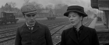 Movie still from “Sons and Lovers” (1960), directed by Jack Cardiff – A man and a woman standing next to each other on train tracks; Close Up shot, Over the shoulder angle