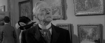 Movie still from “Sons and Lovers” (1960), directed by Jack Cardiff – An older man in a suit and tie; Close Up shot, Low angle