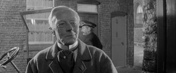 Movie still from “Sons and Lovers” (1960), directed by Jack Cardiff – An older man in a suit and tie; Close Up shot, Over the shoulder angle