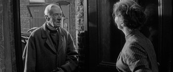 Movie still from “Sons and Lovers” (1960), directed by Jack Cardiff – An older man and a younger woman are looking at each other; Medium shot, Over the shoulder angle