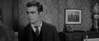 Movie still from “Sons and Lovers” (1960), directed by Jack Cardiff – A man in a suit and tie in front of a picture; Close Up shot, Over the shoulder angle