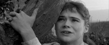 Movie still from “Sons and Lovers” (1960), directed by Jack Cardiff – A person holding a tree trunk; Close Up shot, Low angle