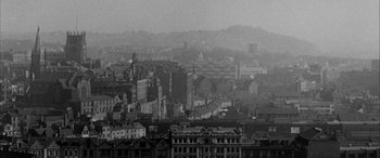 Movie still from “Sons and Lovers” (1960), directed by Jack Cardiff – A black - and - white photo of a city skyline; Extreme Wide shot, High angle