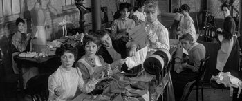 Movie still from “Sons and Lovers” (1960), directed by Jack Cardiff – A black and white photo of a group of people working; Medium shot, High angle