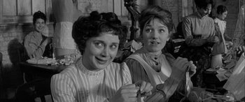 Movie still from “Sons and Lovers” (1960), directed by Jack Cardiff – A couple of women standing next to each other; Medium shot, Over the shoulder angle