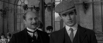 Movie still from “Sons and Lovers” (1960), directed by Jack Cardiff – A man and a young boy in suits and hats; Close Up shot, Low angle