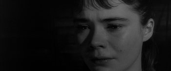 Movie still from “Sons and Lovers” (1960), directed by Jack Cardiff – A young person is looking at the camera with tears in their eyes; Close Up shot, Over the shoulder angle