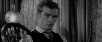 Movie still from “Sons and Lovers” (1960), directed by Jack Cardiff – A young man in a vest and a tie; Close Up shot, Low angle