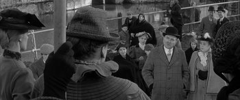 Movie still from “Sons and Lovers” (1960), directed by Jack Cardiff – A group of people standing next to each other on a bridge; Medium shot, Over the shoulder angle