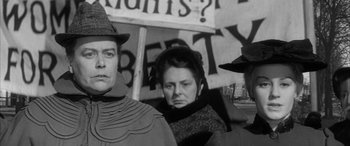 Movie still from “Sons and Lovers” (1960), directed by Jack Cardiff – A black and white photo of a man and two women; Close Up shot, Low angle