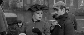 Movie still from “Sons and Lovers” (1960), directed by Jack Cardiff – A man and a woman wearing hats and gloves; Medium shot, Over the shoulder angle