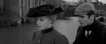 Movie still from “Sons and Lovers” (1960), directed by Jack Cardiff – A woman wearing a hat and a long coat; Close Up shot, Over the shoulder angle