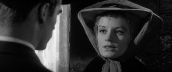 Movie still from “Sons and Lovers” (1960), directed by Jack Cardiff – A black and white photo of a woman wearing a hat; Close Up shot, Over the shoulder angle