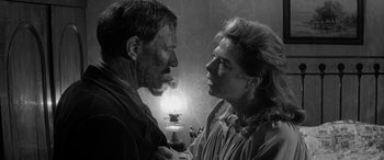 Movie still from “Sons and Lovers” (1960), directed by Jack Cardiff – An old photo of a man and a woman face to face; Close Up shot, Over the shoulder angle