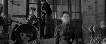 Movie still from “Sons and Lovers” (1960), directed by Jack Cardiff – An old photo of a woman sitting on a bench; Medium shot, Low angle