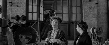 Movie still from “Sons and Lovers” (1960), directed by Jack Cardiff – An old photo of a woman with a hat on; Medium shot, Over the shoulder angle