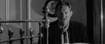 Movie still from “Sons and Lovers” (1960), directed by Jack Cardiff – A black and white photo of a man in a suit and tie; Close Up shot, Low angle