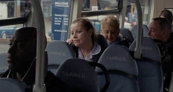 Movie still from “Sorry We Missed You” (2019), directed by Ken Loach – Two women are sitting on a city bus; Medium shot, High angle