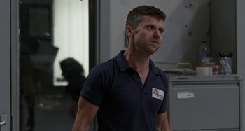 Movie still from “Sorry We Missed You” (2019), directed by Ken Loach – A man in a blue shirt is looking to his left; Medium shot, Low angle