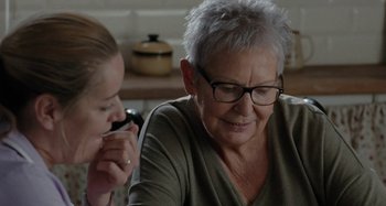 Movie still from “Sorry We Missed You” (2019), directed by Ken Loach – An older woman and a younger woman sitting at a table; Close Up shot, Over the shoulder angle