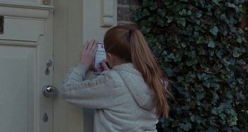 Movie still from “Sorry We Missed You” (2019), directed by Ken Loach – A woman is talking on a cell phone outside; Close Up shot, High angle