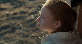 Movie still from “Sorry We Missed You” (2019), directed by Ken Loach – A little girl is looking to the side; Close Up shot, Over the shoulder angle
