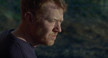 Movie still from “Sorry We Missed You” (2019), directed by Ken Loach – A person with red hair looking to the side; Close Up shot, Over the shoulder angle