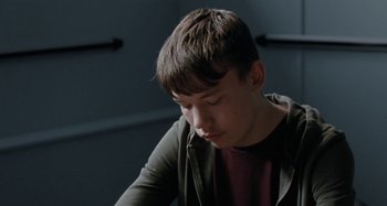Movie still from “Sorry We Missed You” (2019), directed by Ken Loach – A young man sitting in front of a window; Close Up shot, Low angle