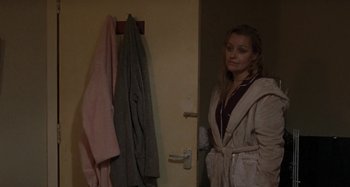 Movie still from “Sorry We Missed You” (2019), directed by Ken Loach – A woman standing in front of a bathroom door; Medium shot, Over the shoulder angle