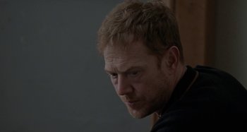 Movie still from “Sorry We Missed You” (2019), directed by Ken Loach – A person with a black shirt on; Close Up shot, Over the shoulder angle