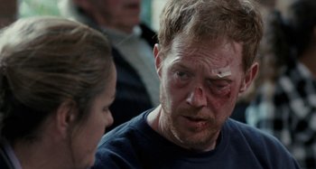 Movie still from “Sorry We Missed You” (2019), directed by Ken Loach – A man with bruises on his face and head; Close Up shot, Over the shoulder angle