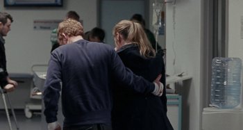 Movie still from “Sorry We Missed You” (2019), directed by Ken Loach – A man and a woman holding hands in a room; Medium shot, Over the shoulder angle