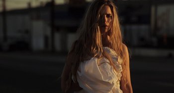Movie still from “Sound of My Voice” (2011), directed by Zal Batmanglij – A woman with long blonde hair wearing a white dress; Medium shot, Low angle