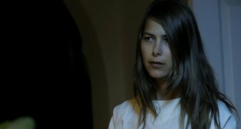 Movie still from “Sound of My Voice” (2011), directed by Zal Batmanglij – A beautiful woman with long dark brown hair looking at the camera; Close Up shot, Over the shoulder angle