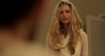 Movie still from “Sound of My Voice” (2011), directed by Zal Batmanglij – A woman with long blonde hair wearing a white shirt; Close Up shot, Over the shoulder angle